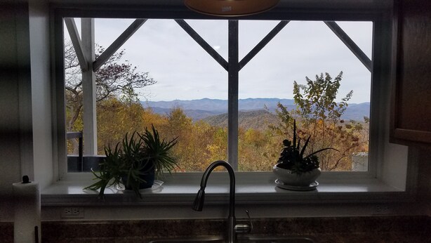 A kitchen window with a view of autumn foliage and mountains. - Mountaintop suite, mountain views, one level, King bed, pet friendly, accessible (Rosman)