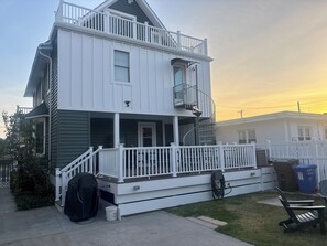 A two-story house with a balcony, a porch, and a garage. - 1913 Classic Victorian Home with manny outdoor spaces. (Wildwood)