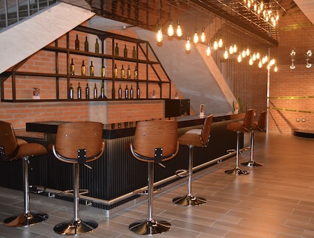 Bar (on property). Cozy Stays Cayala Apartments 7