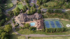 An aerial view of a resort with a swimming pool, tennis courts, and a golf course. - Branson, Stone Bridge Resort Studio (Reeds Spring)
