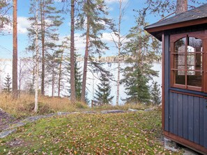 A cabin with a view of a forest and a lake. - Kelosyväri 17 by Interhome (Nilsiä)