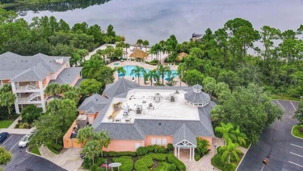 Une propriété résidentielle dotée d’une piscine, de plusieurs bâtiments et offrant une vue sur un lac.