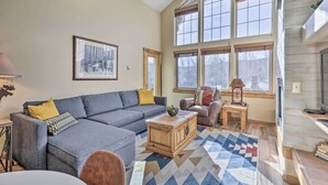 A spacious living room with a grey sofa, a wooden coffee table, and a patterned rug. - Frisco Condo w/ Balcony: 7 Mi to Copper Mountain! (Frisco)