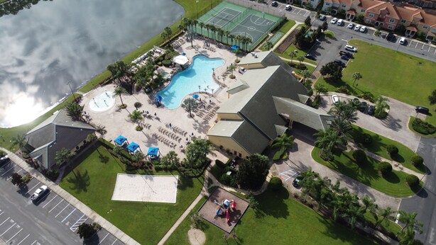 An aerial view of a resort with a swimming pool, tennis courts, and a parking area. - Casita Beth near Disney & Orlando Parks! (Kissimmee)