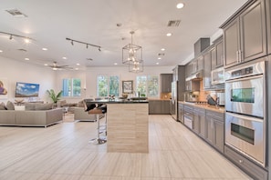 Enjoy a comfortable stay in this open-plan living area with a seating arrangement and kitchen equipped with stainless steel appliances.