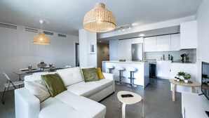 A modern apartment with a living area, dining space, and kitchen.