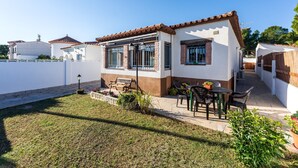 A house with a patio, a small garden, and a white fence. - Chalet 'Casa Thaiker' with Mountain Views, Garden, BBQ & A/C (Miami playa.  Tarragona)
