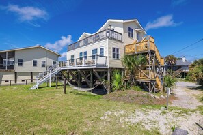 A two-story house with a balcony and a wooden deck. - "The Retreat" at Dolphin's Watch - Up (Folly Beach)