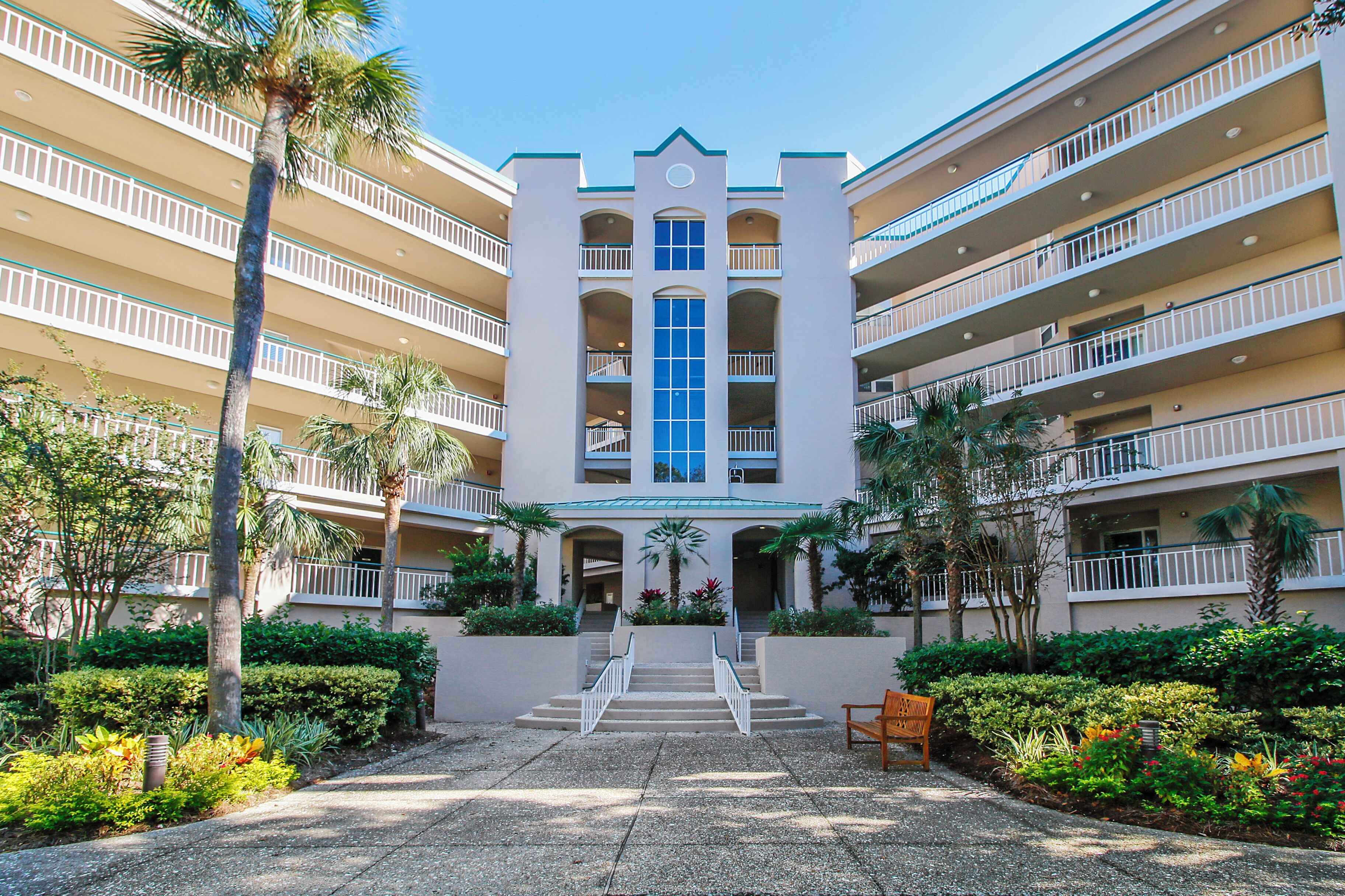A multi-story hotel with a central atrium, balconies, and a landscaped courtyard.
