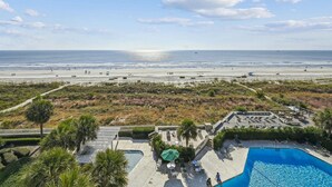 A resort with a pool, beach view, and outdoor seating area. - 5th Floor Villa, Steps to the Beach & Downtown (Hilton Head Island)