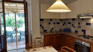A kitchen with wooden cabinets, a gas stove, and a patterned backsplash.