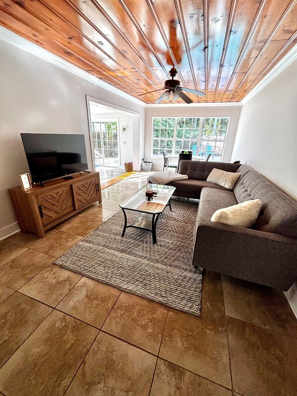 Living Room: Cozy up with a blanket and enjoy your favorite movie, games or book with a view of the gorgeous pool and palm trees in the backyard. Includes a large couch, Roku TV, books and board games.