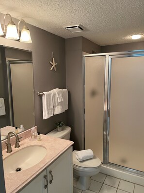 A bathroom with a sink, mirror, toilet, and shower. - RIGHT ON THE SUGAR, WHITE, SAND BEACH!! #1112 AWESOME VIEW! (Destin)