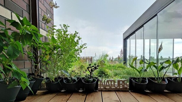 A wooden deck with potted plants and a sign that reads "NATURE". - Unique Apartment With Amazing 90 m² Roof Terrace (Wroclaw)