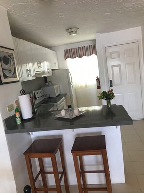 Fridge, microwave, oven, stovetop - Seascape Villa 403E Jolly Hbr is a waterside  condo  10 mins walk  to the Beach. (Jolly Harbour)