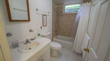 Bathtub, towels, soap, toilet paper