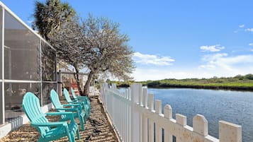 Relax in Adirondack chairs along the serene riverside, taking in the view of the calm water.