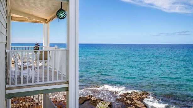 A coastal building with a balcony overlooking the sea. - Hale Kona Kai 312 - Absolute Oceanfront Condo with wraparound lanai (Kailua Kona)
