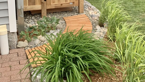 A wooden gate with a lattice design, leading to a covered porch area. - Historic Shoreline Home minutes to Stonington Village and Mystic! (Stonington)