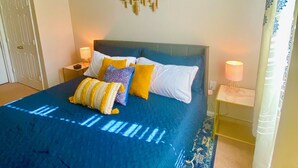 A bedroom with a large bed, two bedside tables, a ceiling fan, and a wall art piece. - Spacious 2bd apt in South Huntsville, close to Redstone Arsenal & downtown!! (Huntsville)