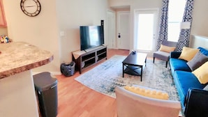 A living room with a TV, sofa, coffee table, and a ceiling fan. - Spacious 2bd apt in South Huntsville, close to Redstone Arsenal & downtown!! (Huntsville)