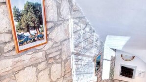 A staircase with wooden steps leading to a stone wall. - Istrian stone house with pool for 8 persons (Gajana)