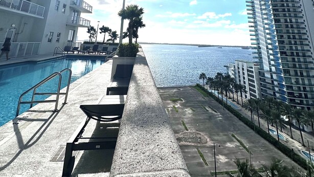 A poolside area with a view of the sea, surrounded by high-rise buildings. - Partial Ocean 3 Beds -1 bath  Brickell @ownpm10 (Miami)