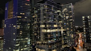 A modern high-rise building with multiple floors, large windows, and a prominent 'CONRAD' sign at the top. - Partial Ocean 3 Beds -1 bath  Brickell @ownpm10 (Miami)