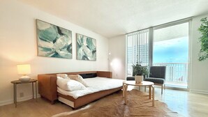 A modern bedroom with a bed, a small table, a chair, and a large window with a view of the city. - Partial Ocean 3 Beds -1 bath  Brickell @ownpm10 (Miami)