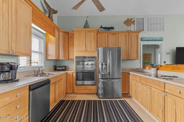 Enjoy cooking in this well-equipped kitchen with a dishwasher, double oven, and refrigerator.