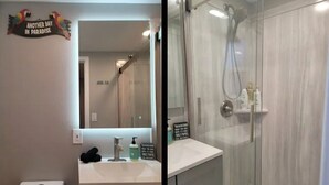 A bathroom with a white sink, a mirror, and a shower with a glass door. - Modern Luxury Oasis Near San Francisco/Oakland (Hayward)