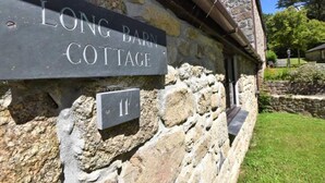 A stone cottage with a sign reading "LONG BARN COTTAGE" and a house number "11". - The Long Barn for Families, Pets & Workers (Penzance)