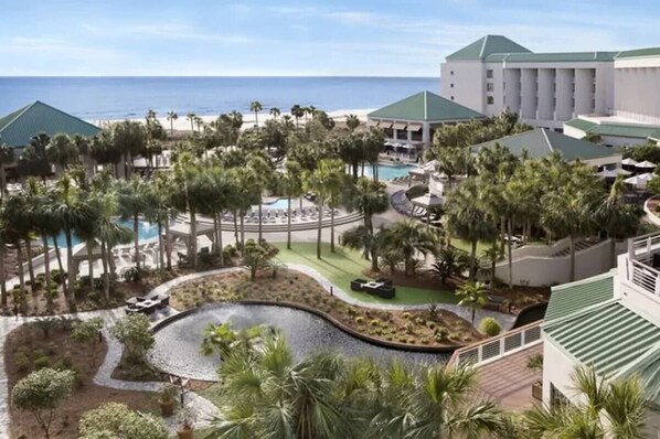 Surrounded by lush greenery and palm trees, this resort offers a tranquil atmosphere near the beach.