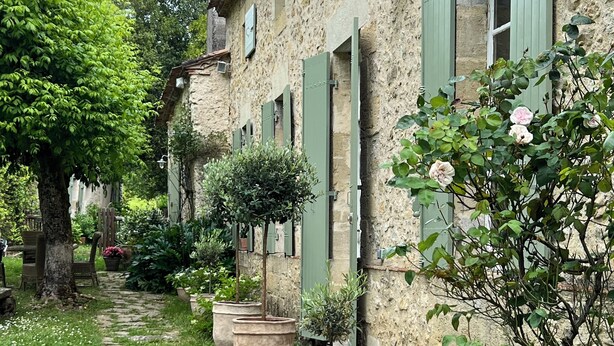 A stone building with green shutters, a stone pathway, and potted plants. - COUNTRY HOME (Castelnau-sur-Gupie)