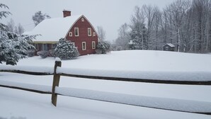 A red brick house with a snow-covered roof and yard. - A cozy home nestled in the Green Mountains of Vermont! (Pownal)