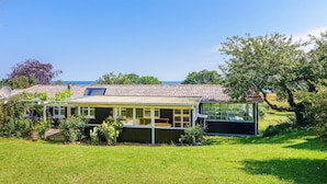 A two-story house with a balcony, a garden, and a view of the sea. - Gorgeous home in Svaneke with WiFi (Svaneke)