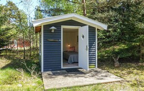 A small, single-room cabin with a sloped roof, a door, and a window. - 4 bedroom lovely home in Nexø (Nexø)