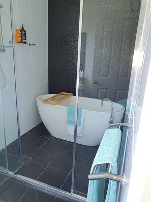 Bathtub, hair dryer, towels, soap