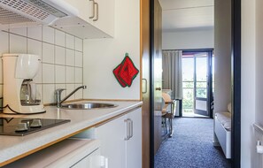 Enjoy a warm cup of coffee in the fully equipped kitchen, complete with a coffee maker and sink.