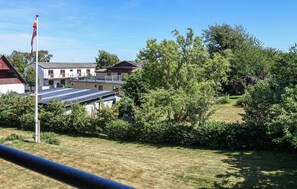 Surrounded by lush greenery, this residential area offers a serene natural setting with a mix of architectural styles.
