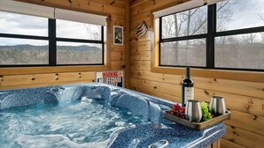 A wooden cabin with a hot tub, a warning sign, and a bottle of Arrow wine. - Smoky Mountain Fall Colors Private Pool Hot Tub Theater and Cozy Mountain Escape (Cosby)