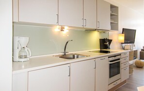 Fridge, stovetop, dishwasher, coffee/tea maker