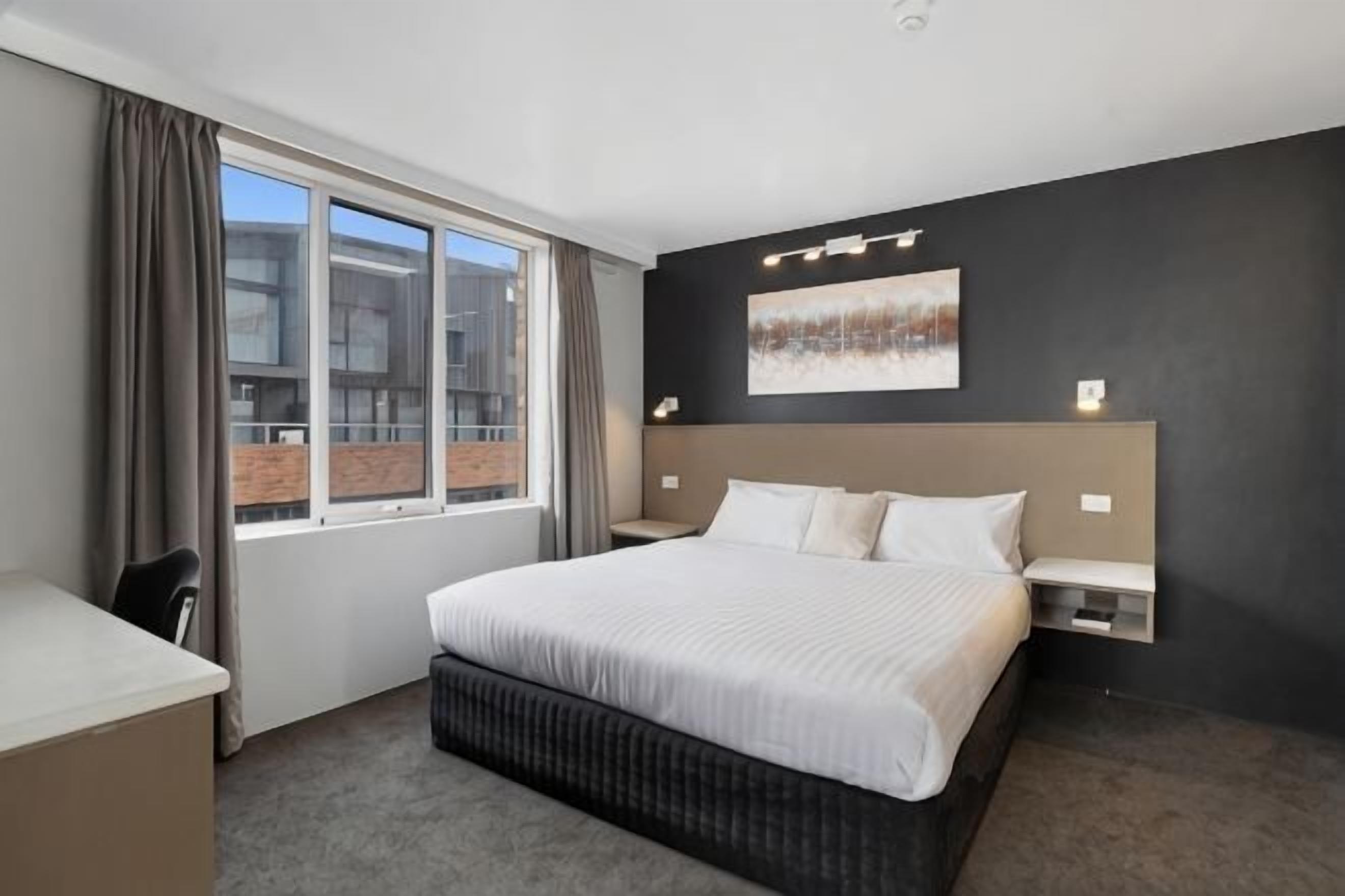 Desk, iron/ironing board, bed sheets
