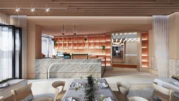A modern dining area with a marble bar, wooden chairs, and a long table set for a meal.