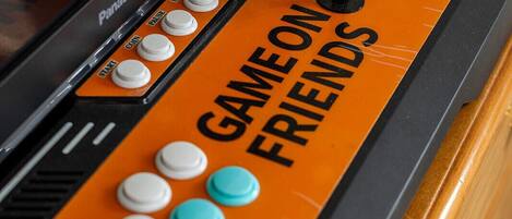 A game console with a "GAME ON FRIENDS" label and various buttons.