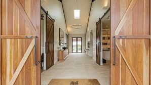 A hallway with wooden sliding doors leading to a kitchen area. - Beechmont Estate (Beechmont)