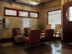 A room with a sofa, armchairs, a small table, and a potted plant. - Niagara Hotel (Bangkok)