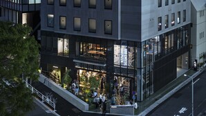 A modern building with a ground-level restaurant and upper-floor residential or office spaces. - all day place shibuya (Tokyo)
