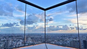 A high-rise room with a panoramic city view through large windows. - all day place shibuya (Tokyo)