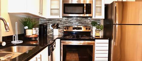 Microwave, coffee/tea maker, cookware/dishes/utensils, dining tables